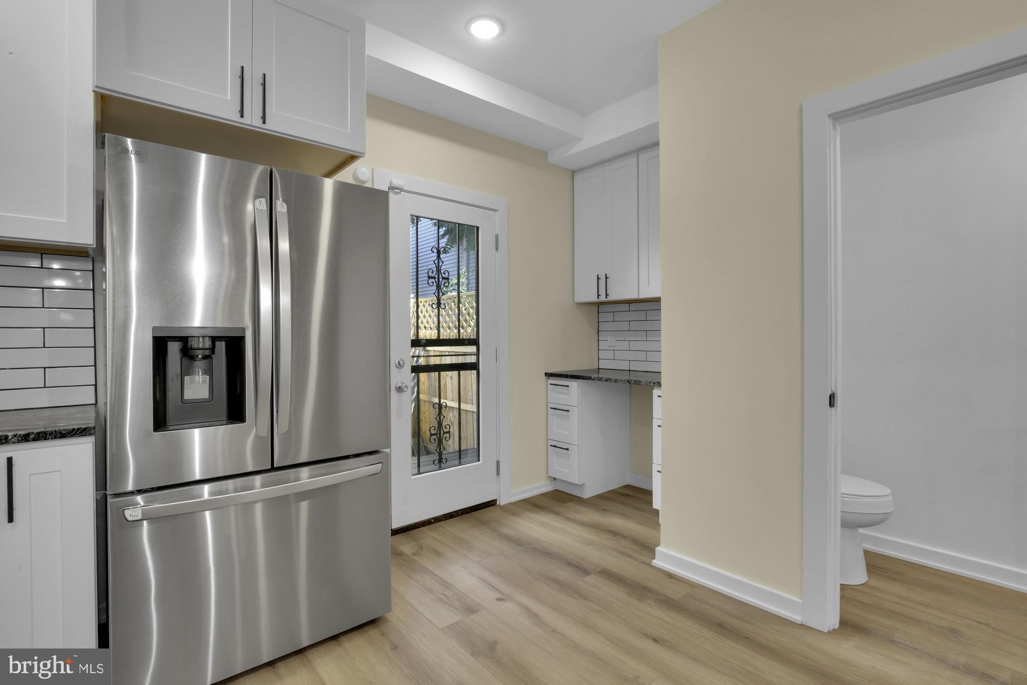 2670 Braddock Street Philadelphia, PA 19125 - Photo 10 of 47 a kitchen with stainless steel appliances a refrigerator and wooden floor