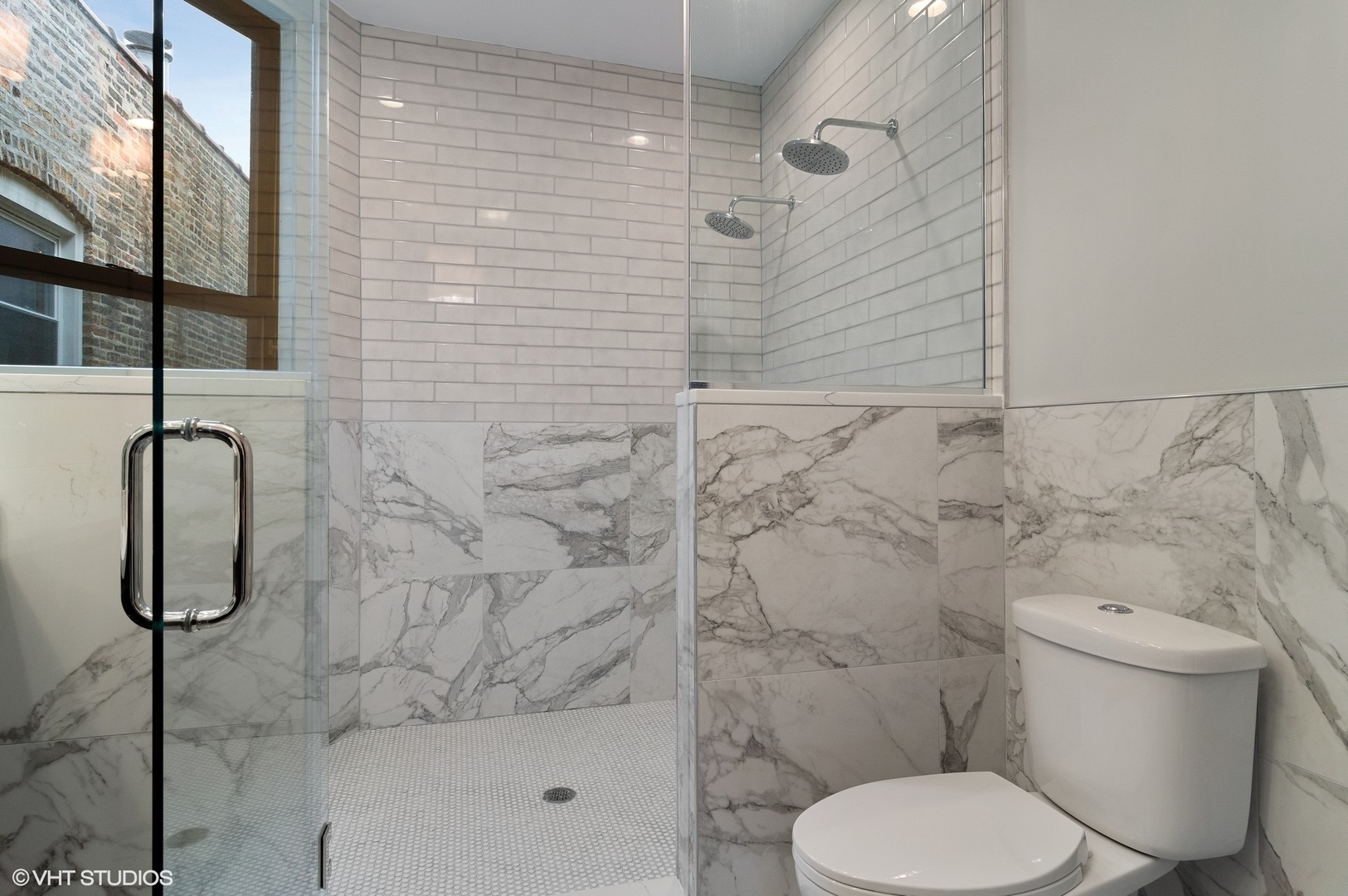 1211 West Addison Street, Unit 2 Chicago, IL 60613 - Photo 11 of 16 a white toilet sitting next to a shower