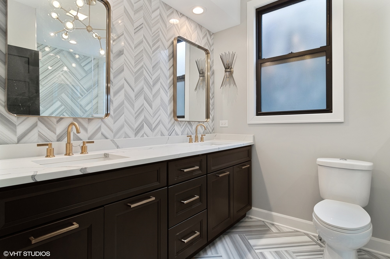 1211 West Addison Street, Unit 2 Chicago, IL 60613 - Photo 13 of 16 a bathroom with a toilet sink and mirror