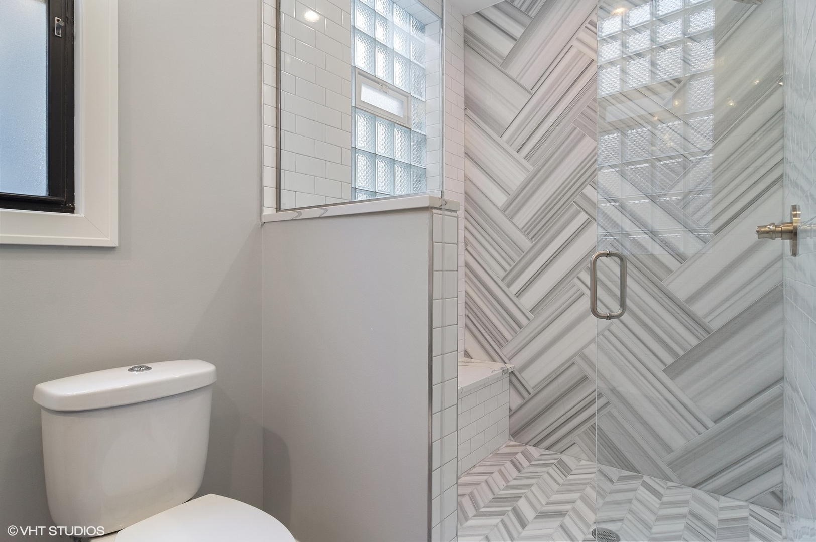 1211 West Addison Street, Unit 2 Chicago, IL 60613 - Photo 14 of 16 a white toilet sitting next to a bathroom