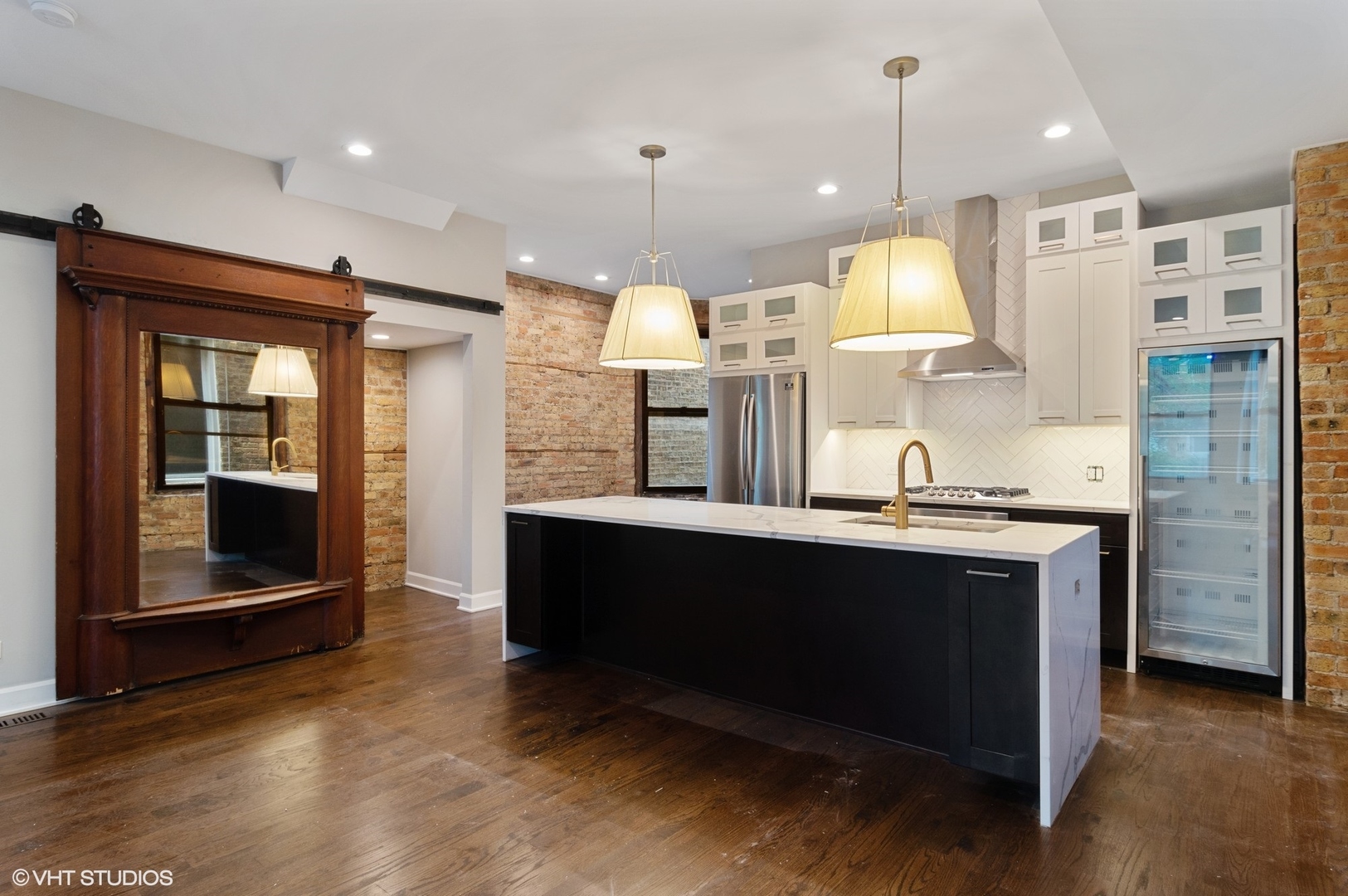1211 West Addison Street, Unit 2 Chicago, IL 60613 - Photo 3 of 16 a kitchen with stainless steel appliances granite countertop a sink a stove and a refrigerator