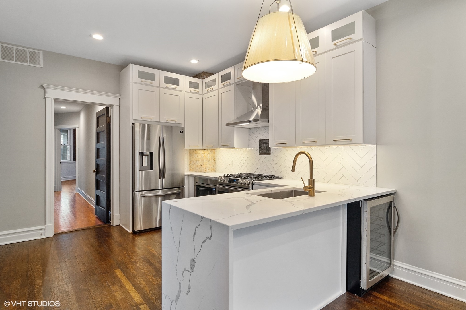 1211 West Addison Street, Unit 2 Chicago, IL 60613 - Photo 4 of 16 a kitchen with a sink a refrigerator and cabinets