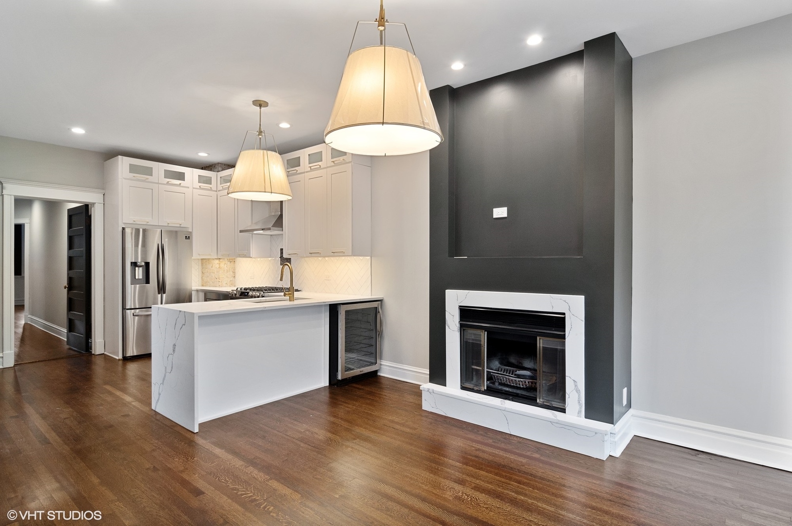 1211 West Addison Street, Unit 2 Chicago, IL 60613 - Photo 5 of 16 a view of a kitchen with a sink and a fireplace