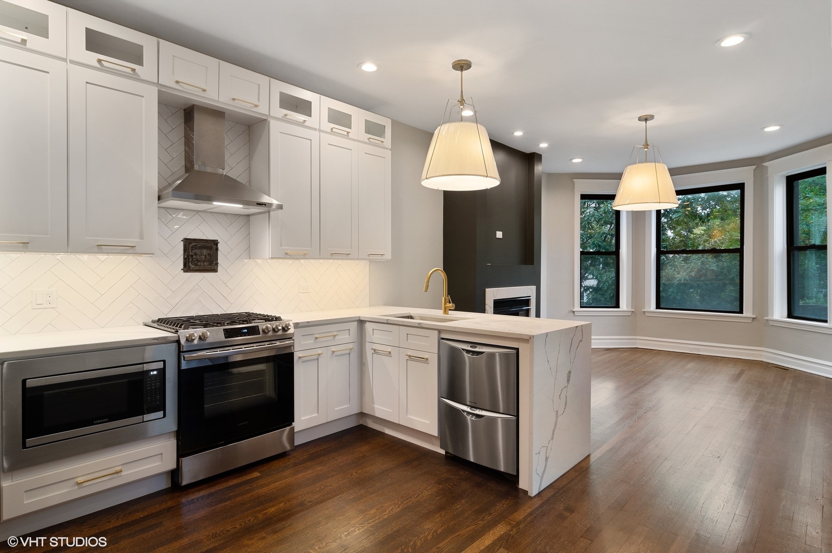 1211 West Addison Street, Unit 2 Chicago, IL 60613 - Photo 6 of 16 a kitchen with stainless steel appliances a stove a sink and a refrigerator