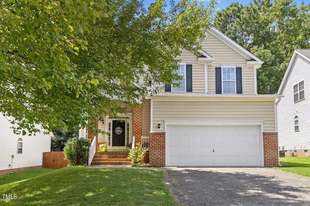 2342 School Creek Place Raleigh, NC 27606 - Photo 1 of 41 a view of a yard in front of a house with plants and large tree