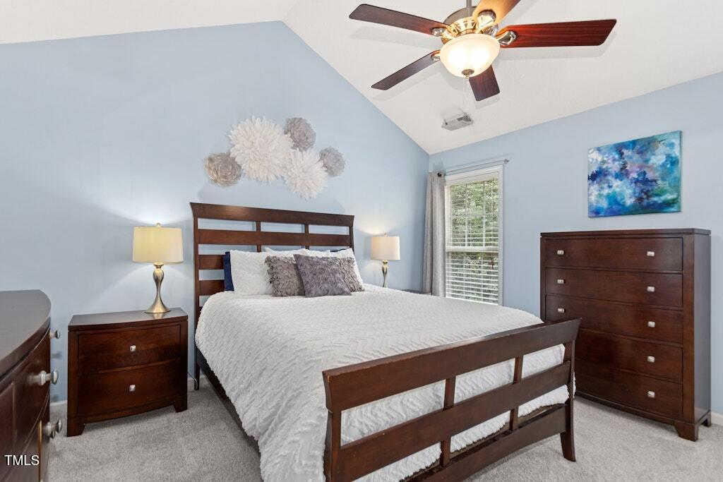 2342 School Creek Place Raleigh, NC 27606 - Photo 17 of 41 a bedroom with a bed and a chandelier