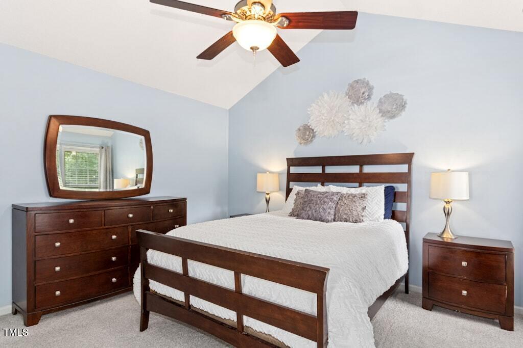 2342 School Creek Place Raleigh, NC 27606 - Photo 20 of 41 a bedroom with a bed and a lamp on dresser