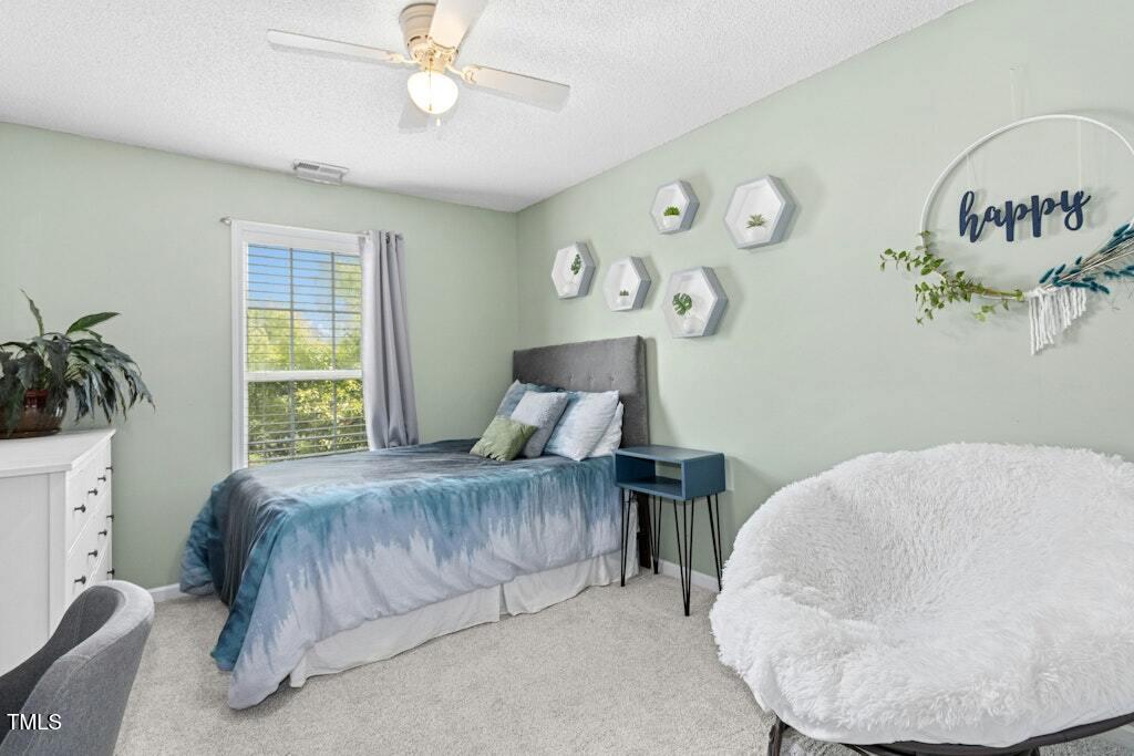 2342 School Creek Place Raleigh, NC 27606 - Photo 25 of 41 a bedroom with a bed and window