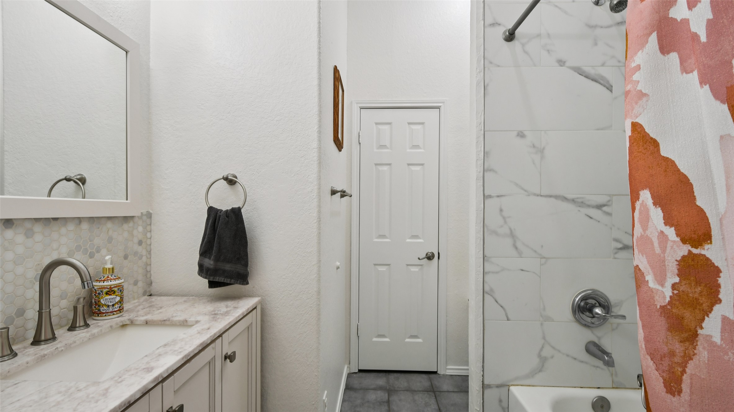 13131 Crane Road Buda, TX 78610 - Photo 13 of 18 a bathroom with a granite countertop sink and a shower