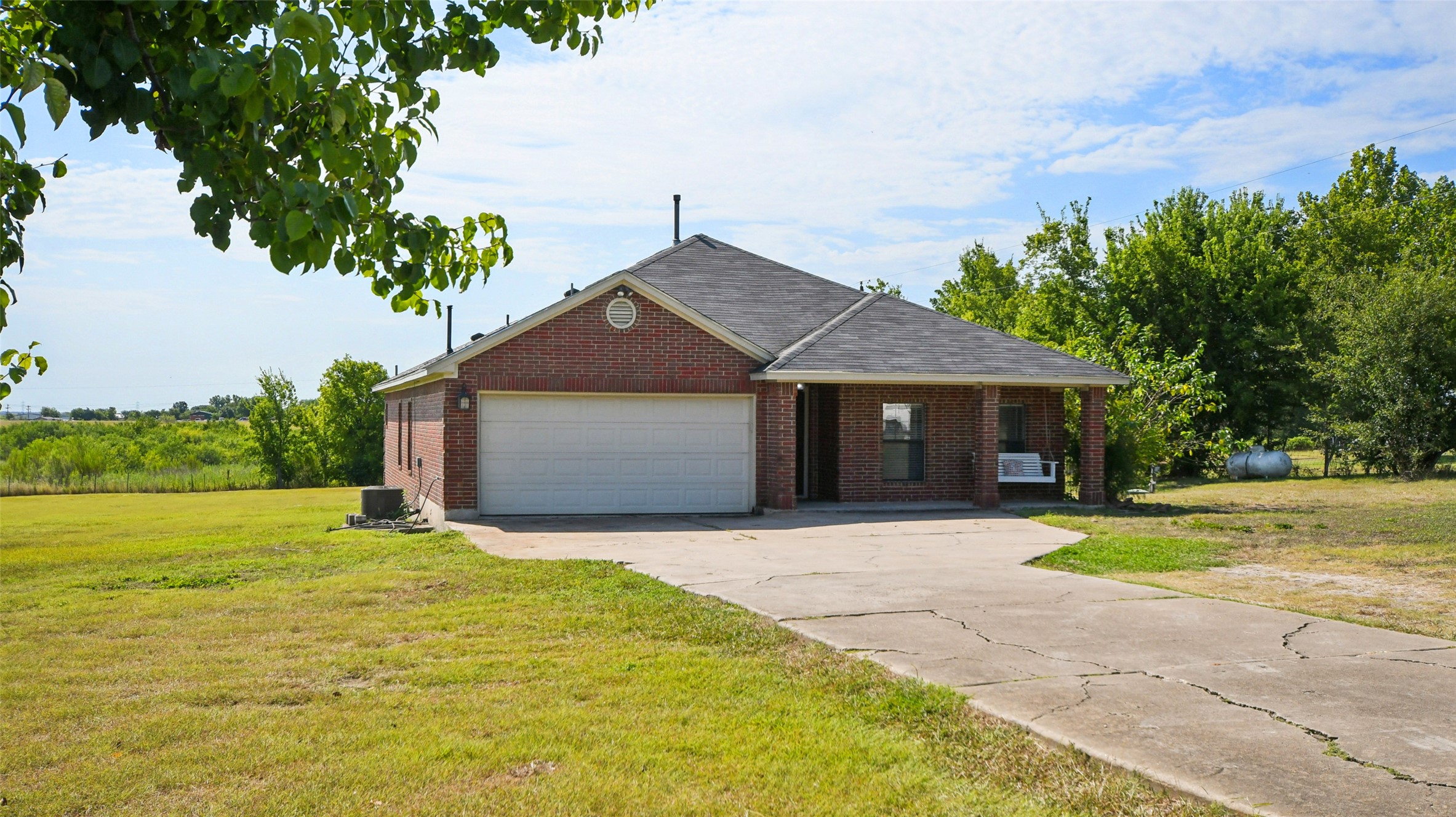 13131 Crane Road Buda, TX 78610 - Photo 3 of 18 a front view of a house with a yard and garage
