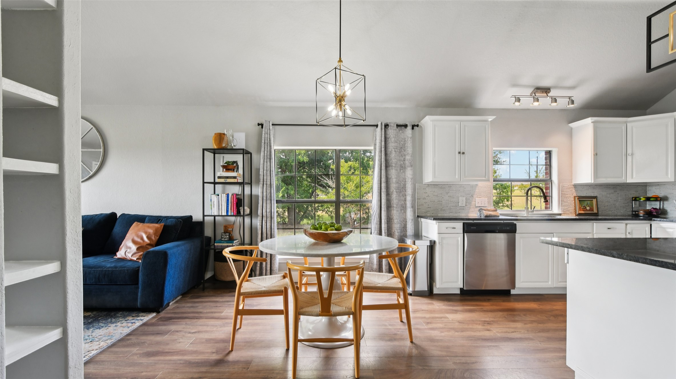 13131 Crane Road Buda, TX 78610 - Photo 8 of 18 a dining room with furniture a chandelier and wooden floor