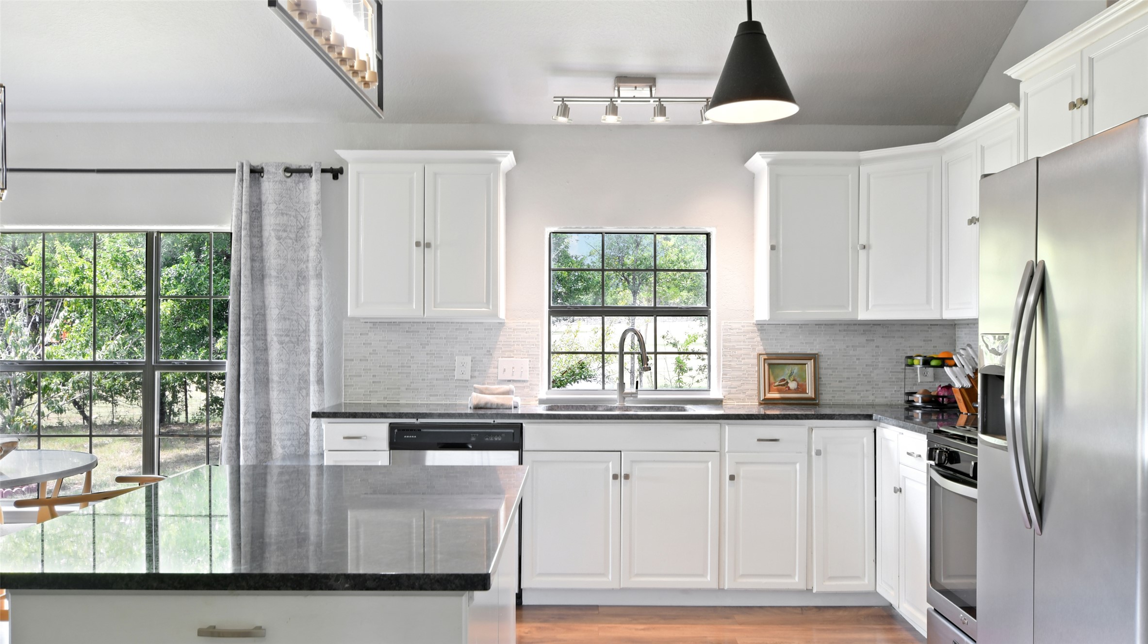 13131 Crane Road Buda, TX 78610 - Photo 10 of 18 a kitchen with white cabinets and window