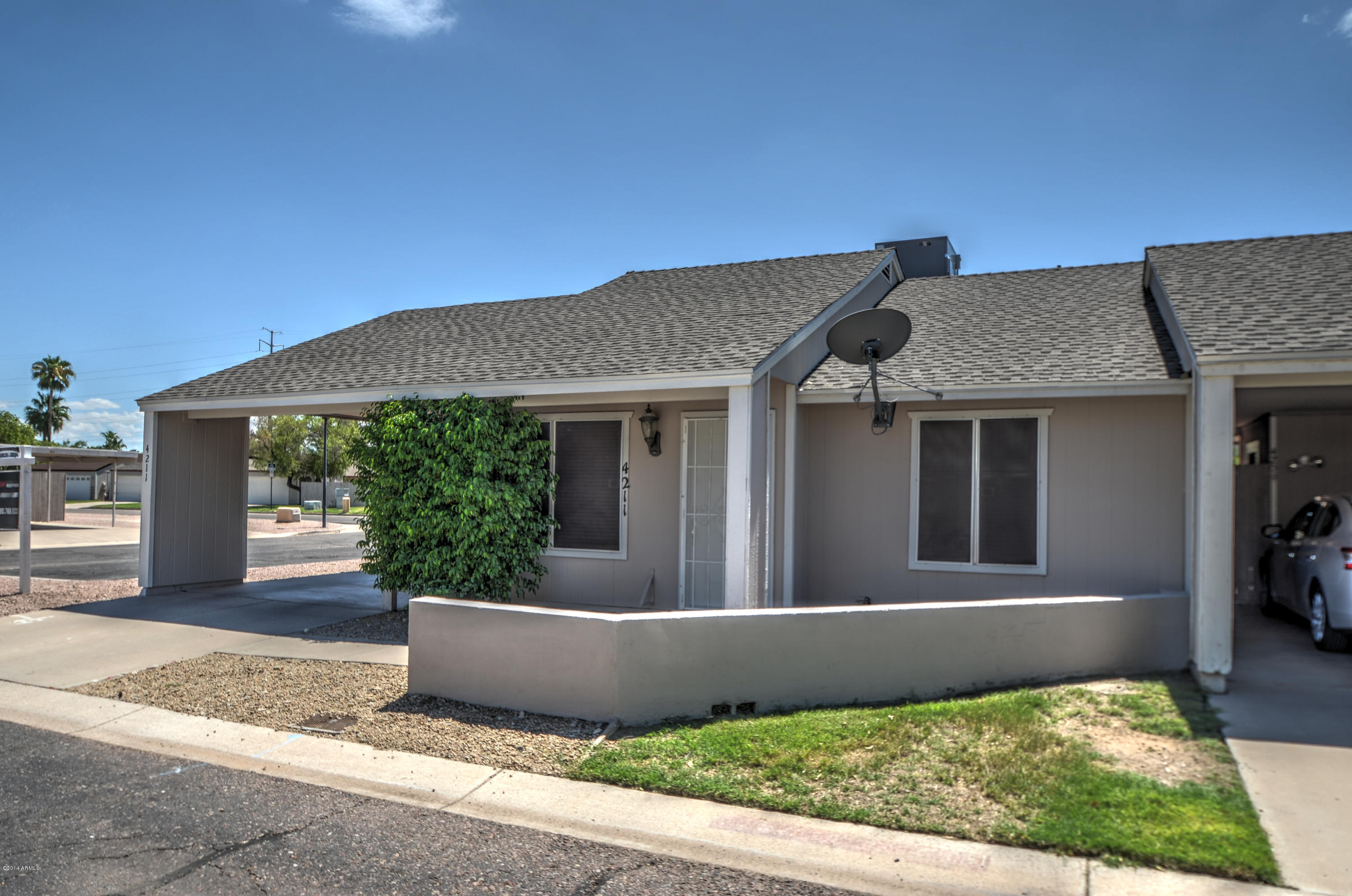 4211 East Carson Road Phoenix, AZ 85042 - Photo 18 of 19 a front view of a house with garden