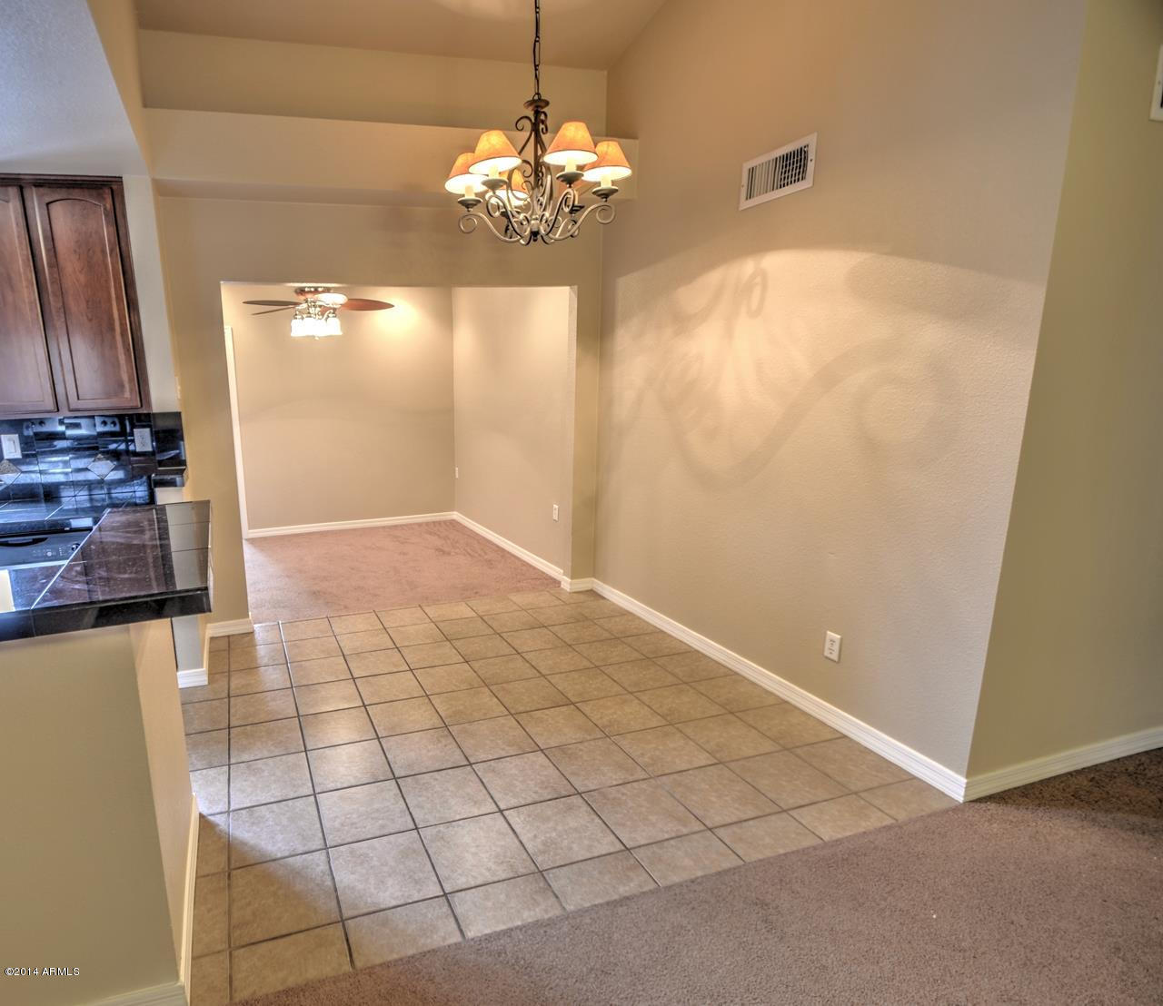 4211 East Carson Road Phoenix, AZ 85042 - Photo 5 of 19 a view of a livingroom with a chandelier fan and windows
