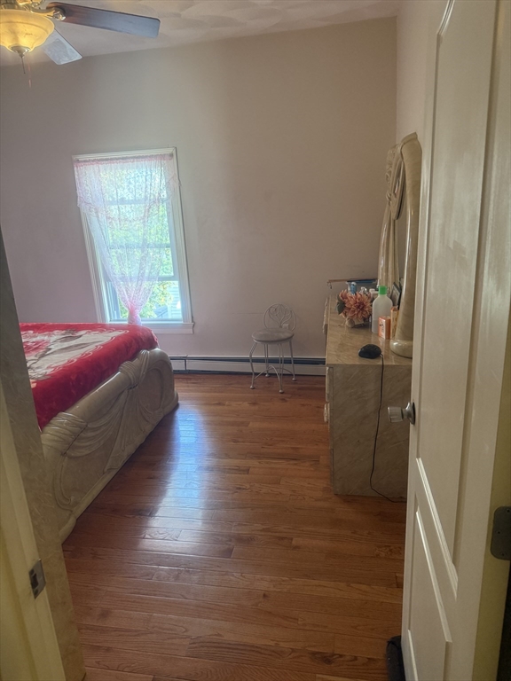 82 2nd Street Medford, MA 02155 - Photo 20 of 23 a room with wooden floor and chair