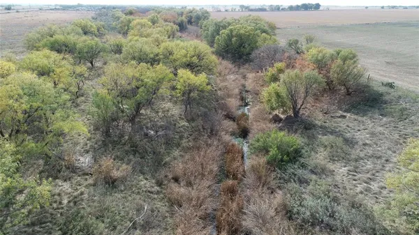 a view of a field with an ocean view