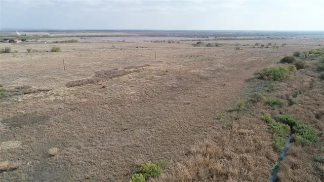 a view of a lake with beach and mountain