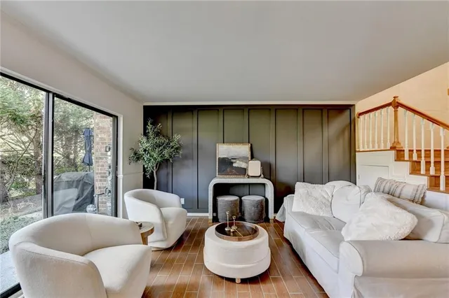 a living room with furniture and a floor to ceiling window