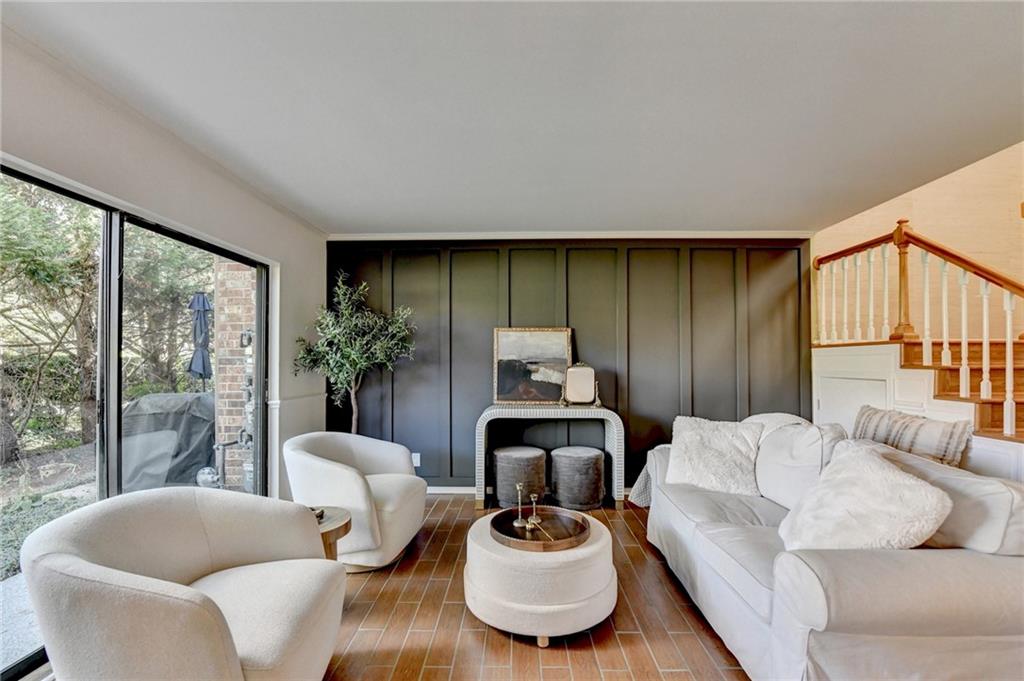 a living room with furniture and a floor to ceiling window