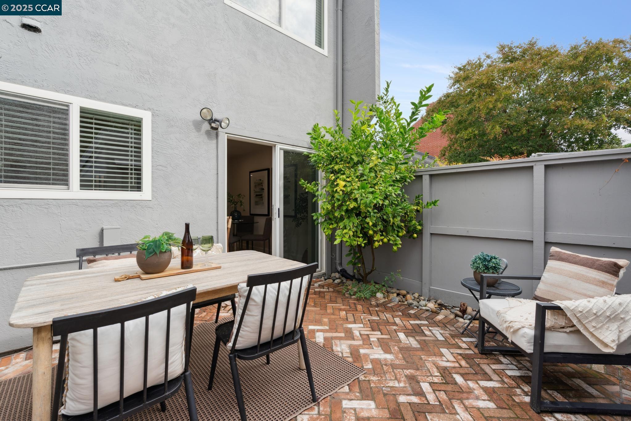 46 Sierra Lane Walnut Creek, CA 94596 - Photo 11 of 31 a view of a patio with table and chairs potted plants and floor to ceiling window