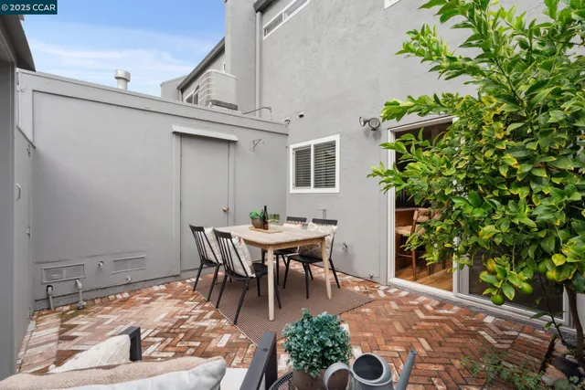 a backyard of a house with a table and chairs