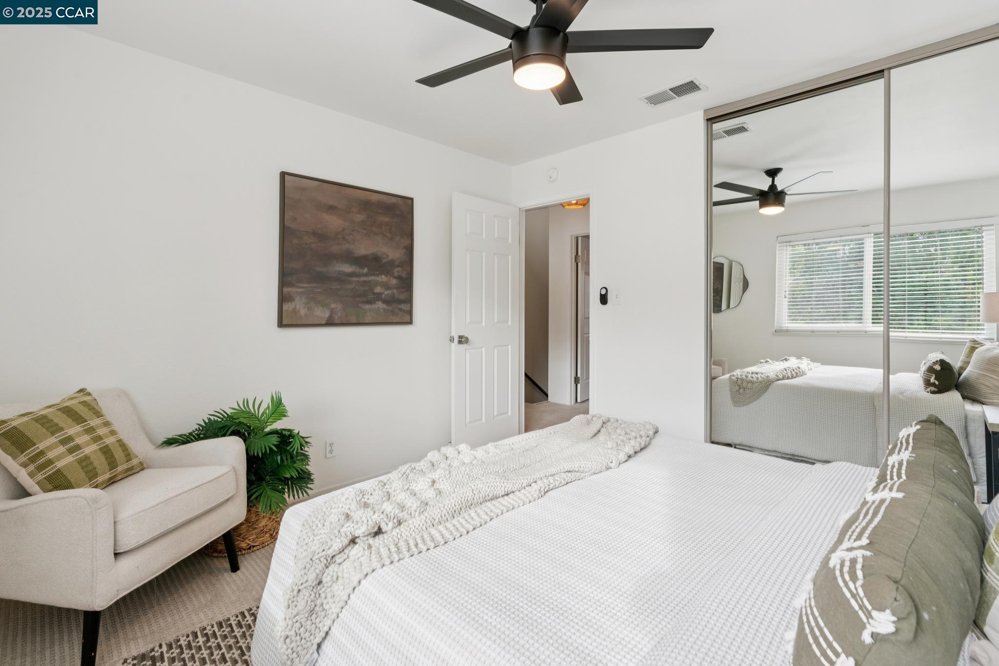46 Sierra Lane Walnut Creek, CA 94596 - Photo 22 of 31 a bedroom with a large bed couch and a window