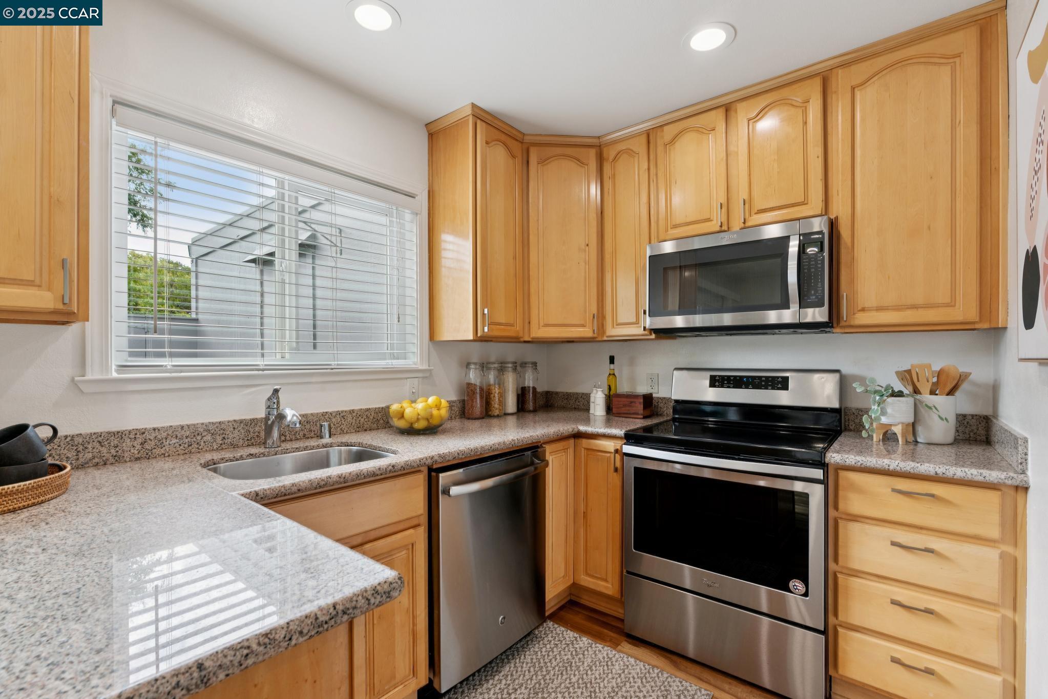 46 Sierra Lane Walnut Creek, CA 94596 - Photo 8 of 31 a kitchen with stainless steel appliances a stove sink microwave and cabinets