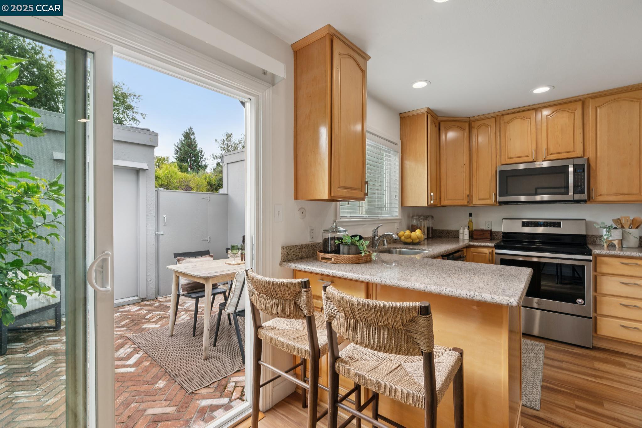46 Sierra Lane Walnut Creek, CA 94596 - Photo 10 of 31 a kitchen with a table chairs microwave and cabinets