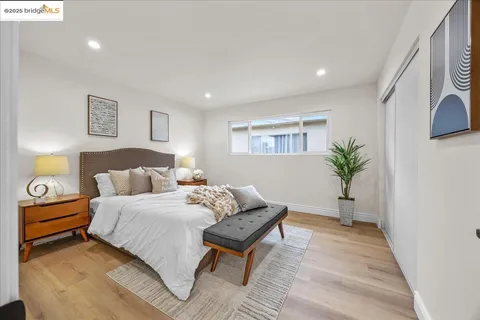 a bedroom with a bed and a potted plant