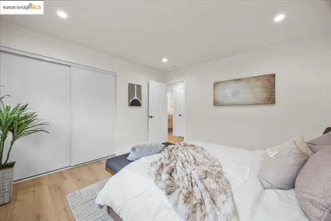 a bathroom with a granite countertop sink a toilet a mirror and shower