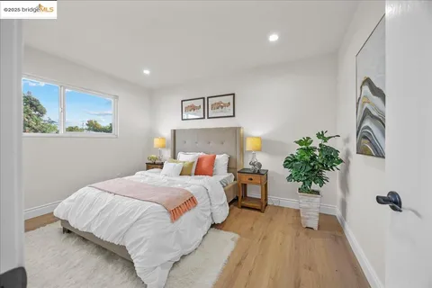 a bedroom with bed and painting on the wall