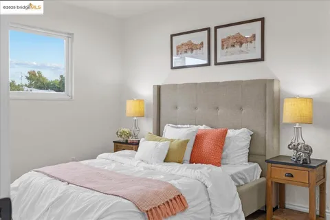 a bedroom with a bed and a potted plant