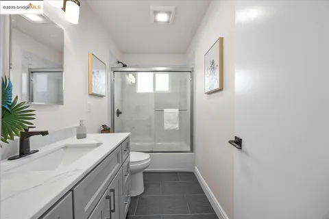 a bedroom with a bed and a night stand