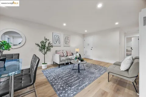 a view of a dining room with furniture and a window