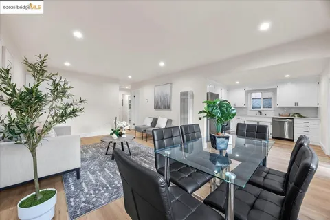 a kitchen with a refrigerator a sink and a stove top oven