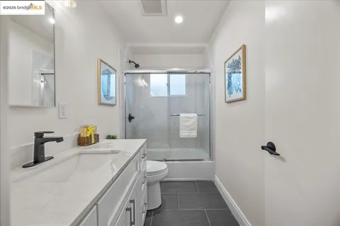 a bathroom with a shower sink and mirror
