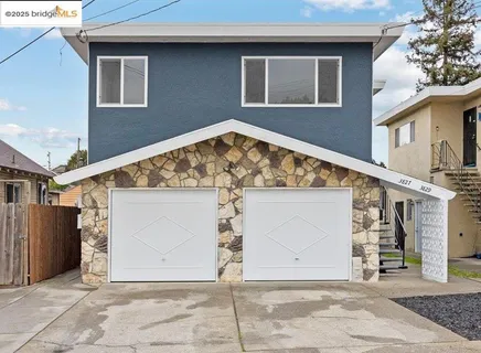a view of a backyard with large trees and wooden fence