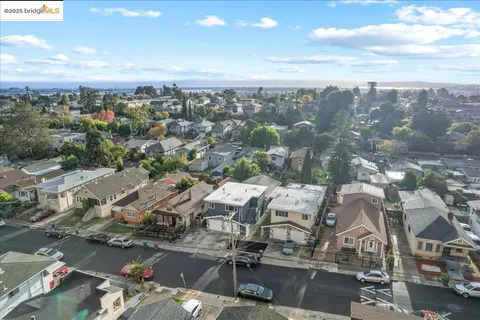 an aerial view of residential houses with outdoor space and swimming pool