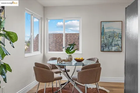 a dining room with furniture and wooden floor