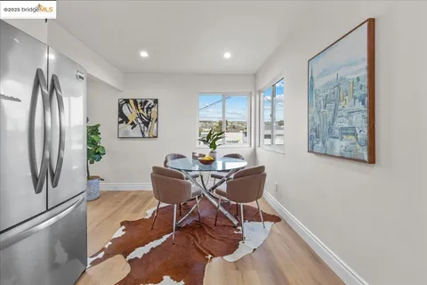 a bedroom with a large bed and a potted plant