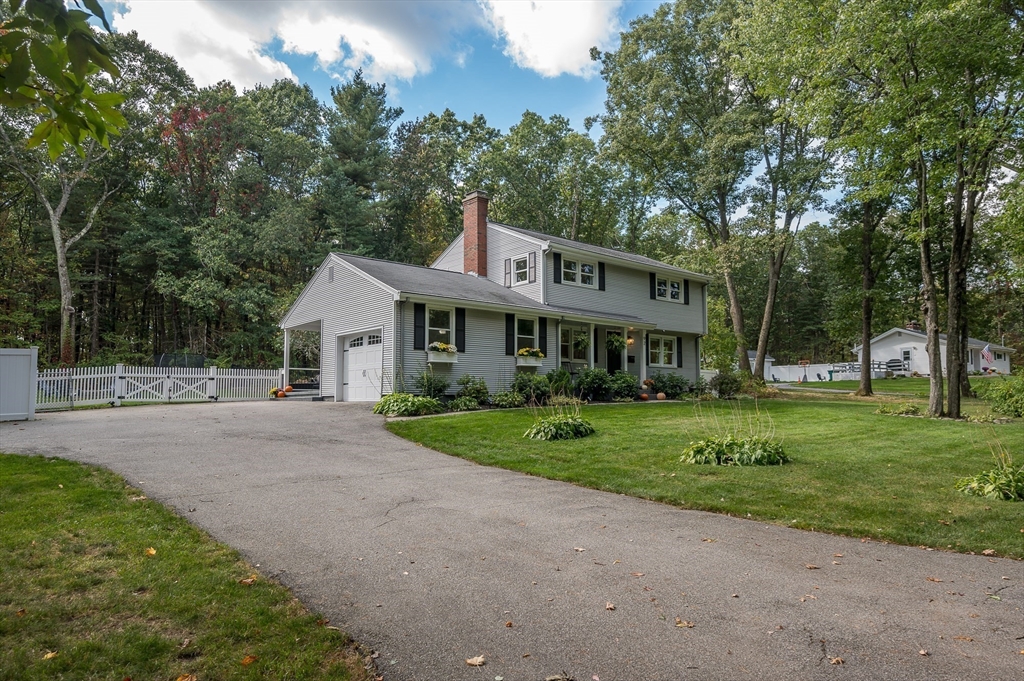 92 Dodge Hill Road Sutton, MA 01590 - Photo 2 of 33 a front view of a house with a yard and trees