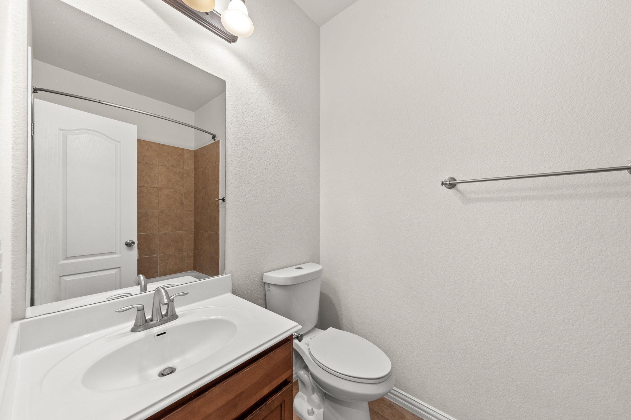 411 Tascate Street Georgetown, TX 78628 - Photo 30 of 41 A well-appointed bathroom features a practical vanity with an integrated sink and an adjacent toilet.