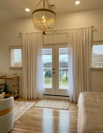 a view of a livingroom with furniture window and wooden floor