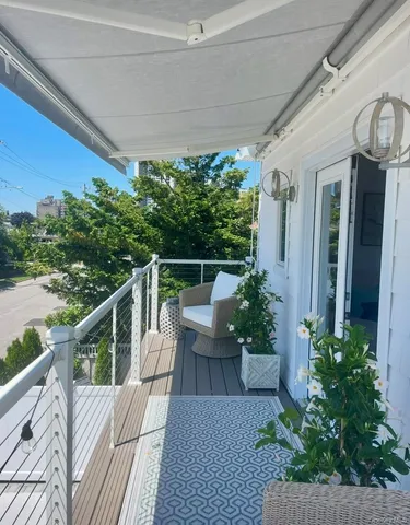 a view of a balcony with furniture