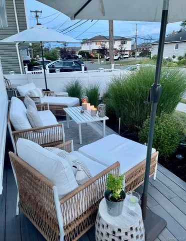 a view of a patio with a table chairs and a fire pit