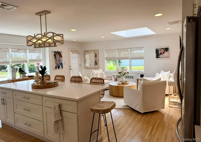 a living room with kitchen island furniture and a chandelier