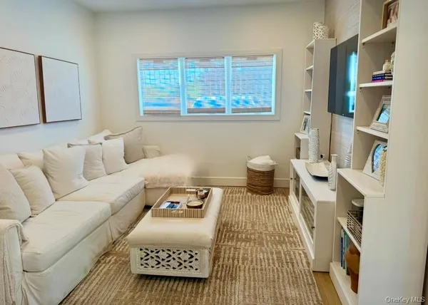 a bedroom with furniture and a book shelf