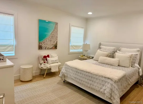 a bedroom with bed and a large window