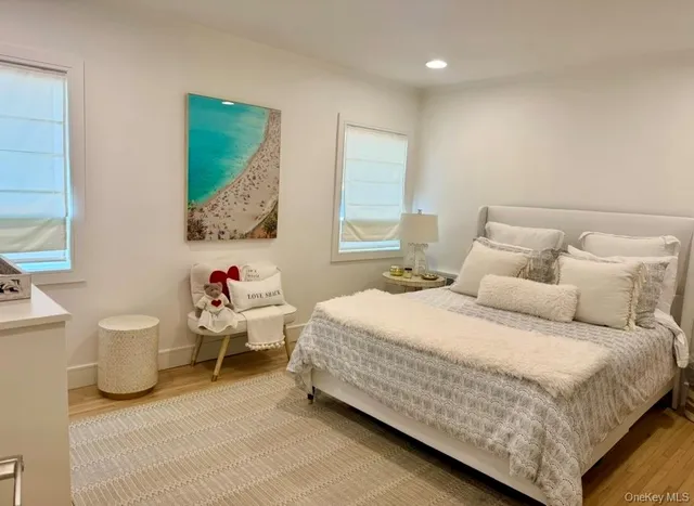 a bedroom with bed and a large window