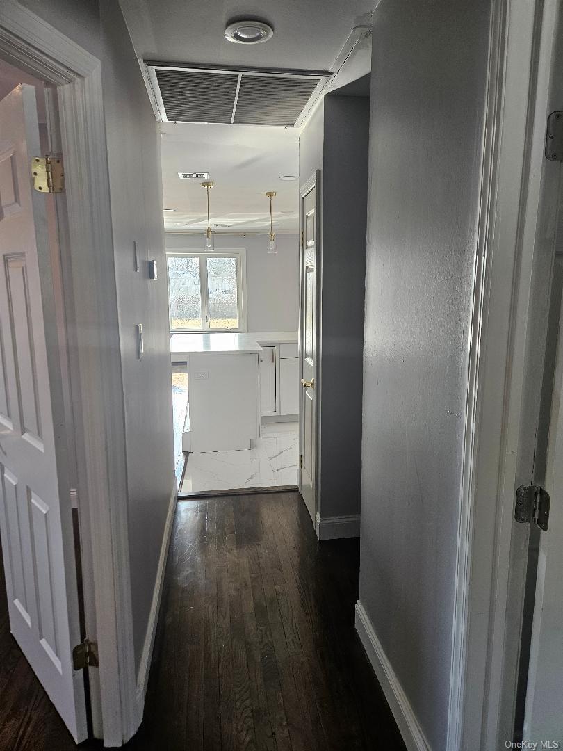 149 Truxton Road Dix Hills, NY 11746 - Photo 14 of 22 Corridor featuring dark wood finished floors and baseboards